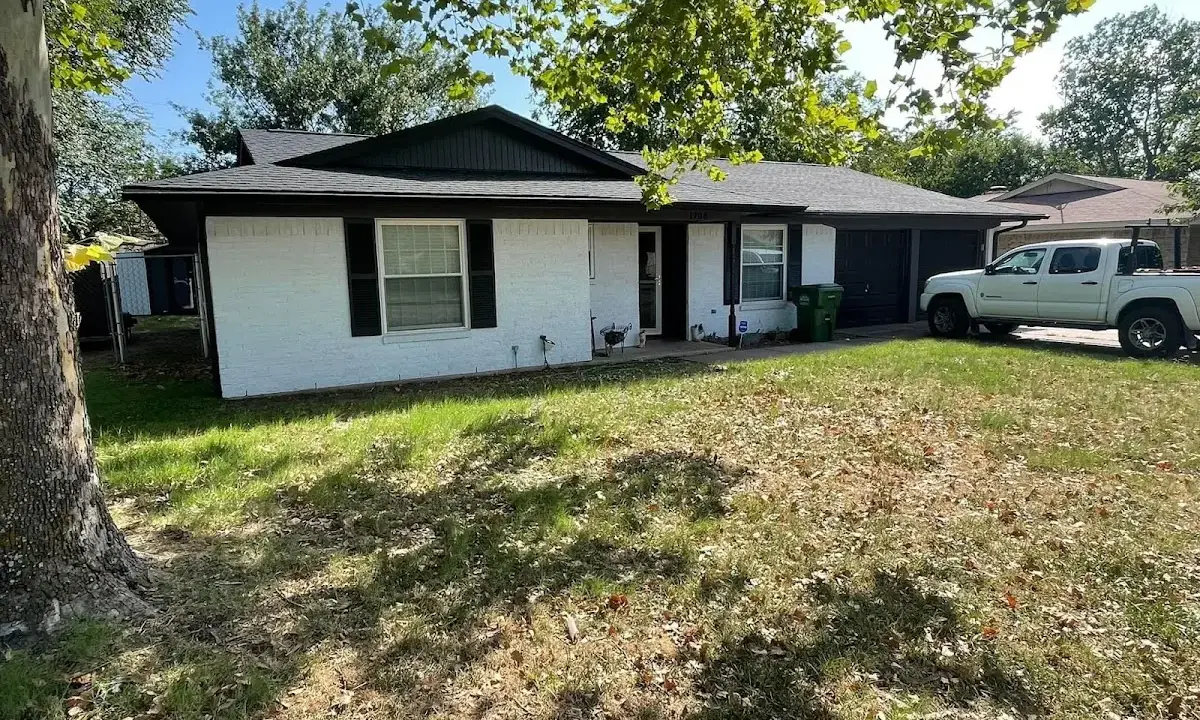 Professional roofing crew working on a residential roof in Shorewood